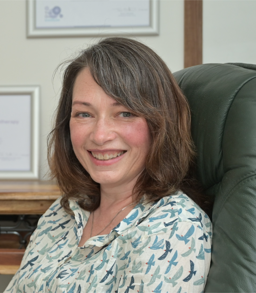 Joyce Elisha, Cognitive Hypnotherapist, smiling in a calm therapy space